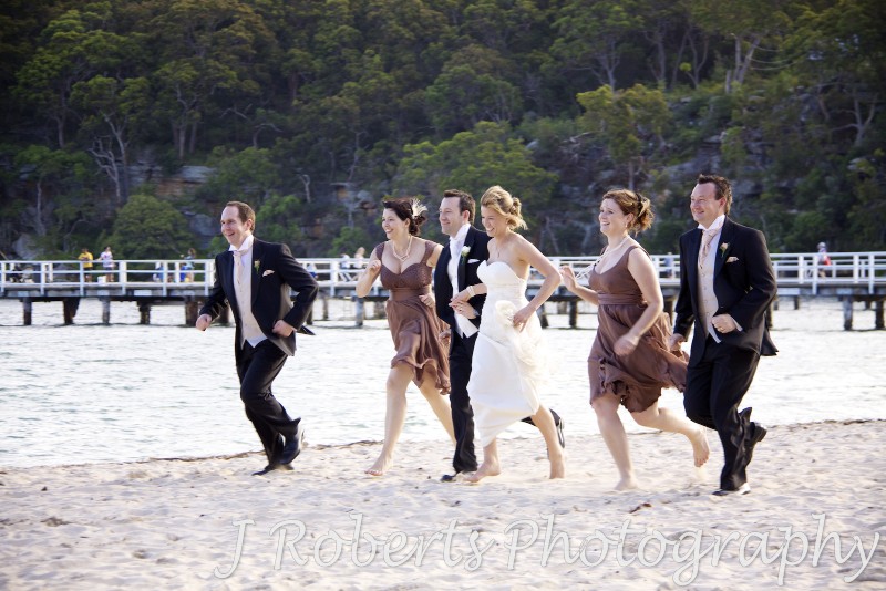 Bridal party running along the beach at Clifton Gardens Sydney - wedding photography sydney